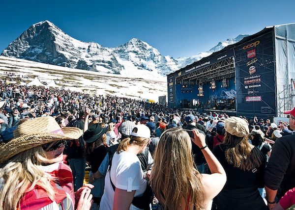 An outdoor music festival in Switzerland with a mountain backdrop